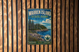 A vintage metal sign for Warren Island State Park in Maine, featuring a scenic landscape with pine trees, rocky cliffs, and a body of water.