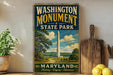 A vintage-style sign for Washington Monument State Park in Maryland, featuring an illustration of the monument surrounded by trees and a path leading to the monument.