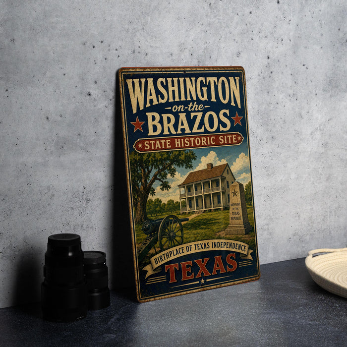 A vintage-style metal sign for Washington on the Brazos State Historic Site, featuring an illustration of a house and a cannon, is displayed on a gray concrete surface.
