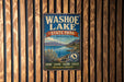 A vintage metal sign for Washoe Lake State Park, Nevada, featuring a scenic landscape with mountains, a lake, and various outdoor activities such as hiking, fishing, and boating.