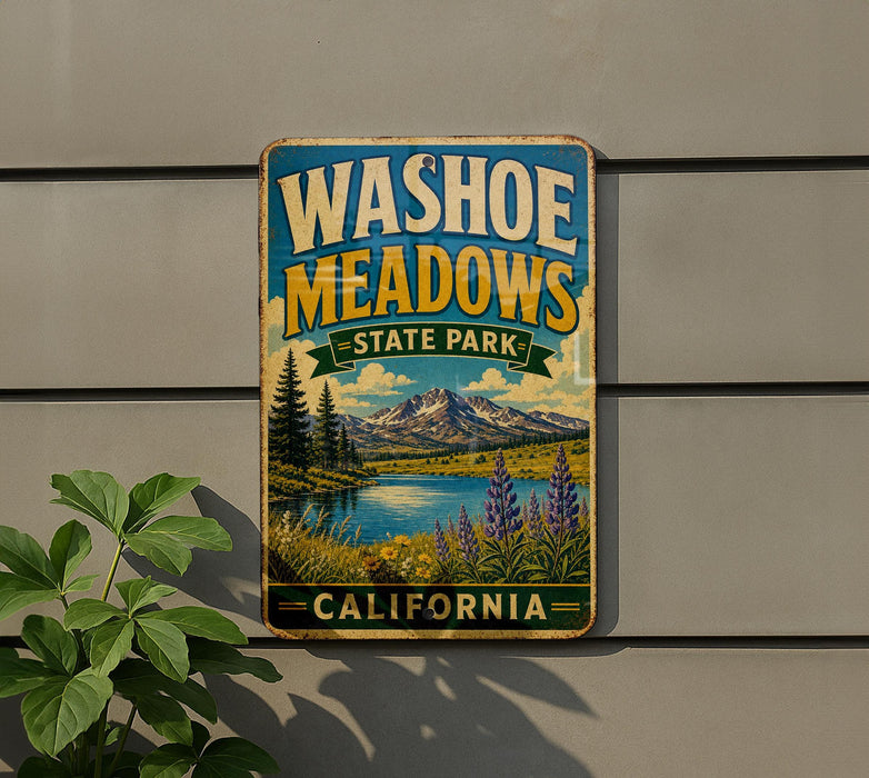 A vintage-style metal sign for Washoe Meadows State Park in California, featuring a scenic landscape with mountains, a lake, and wildflowers.