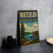 A vintage metal sign for the Waterloo Recreation Area in Michigan, featuring a scenic illustration of a lake, pine trees, and a camp sign.