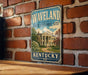 A vintage-style metal sign for the state historic site of Kentucky, featuring a large illustration of a historic building surrounded by trees and a path leading up to it.
