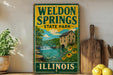 A vintage-style sign for Weldon Springs State Park in Illinois, featuring a scenic illustration of a river, waterfall, and surrounding landscape.