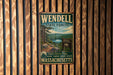 A vintage metal sign for Wendell State Forest in Massachusetts, featuring a scenic image of the forest and a lake.