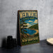 A vintage-style metal sign for Wentworth State Park in New Hampshire, featuring a scenic landscape with a lake, mountains, and pine trees.
