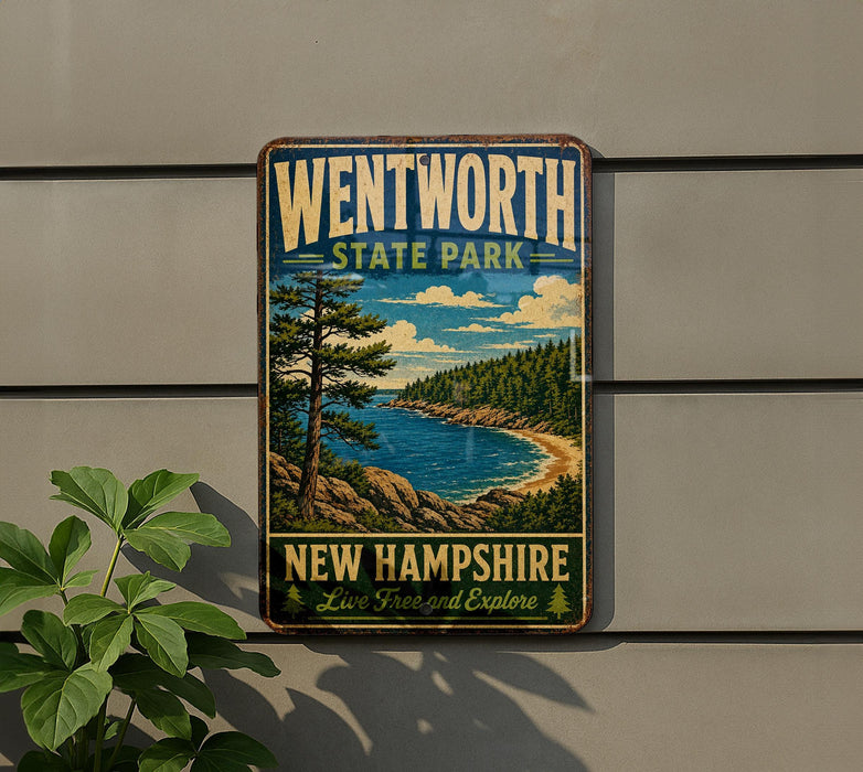 A vintage-style metal sign for Wentworth State Park in New Hampshire, featuring a scenic landscape with pine trees, a lake, and mountains.