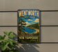 A vintage-style metal sign for Wentworth State Park in New Hampshire, featuring a scenic landscape with pine trees, a lake, and mountains.