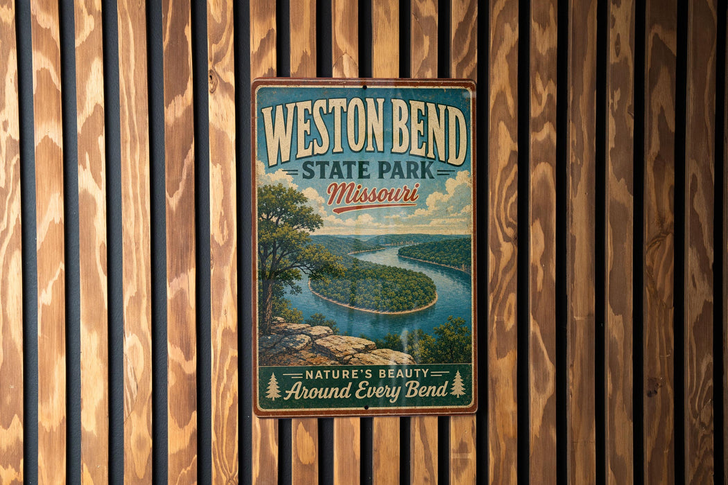 A vintage metal sign for "Weston Bend State Park, Missouri" hangs on a wooden wall, featuring a scenic landscape of a river and mountains.