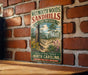 A vintage-style metal sign for Weymouth Woods Sandhills Nature Preserve, featuring a scenic illustration of a forest and flowers, mounted on a brick wall.