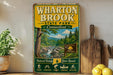 A vintage-style metal sign for Wharton Brook State Park in Connecticut, featuring a scenic image of the park and its surrounding natural beauty.