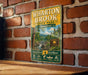 A vintage-style metal sign for Wharton Brook State Park in Connecticut, featuring a scenic image of the park and its surrounding natural beauty.