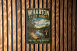 A vintage-style metal sign for Wharton State Forest, featuring a scenic image of a river surrounded by pine trees and a sign indicating the location.