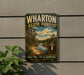 A vintage-style metal sign for Wharton State Forest, featuring a scenic landscape with a river and pine trees, mounted on a wall.