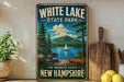 A vintage-style sign for White Lake State Park in New Hampshire, featuring a scenic landscape with a lake, mountains, pine trees, and a sailboat.