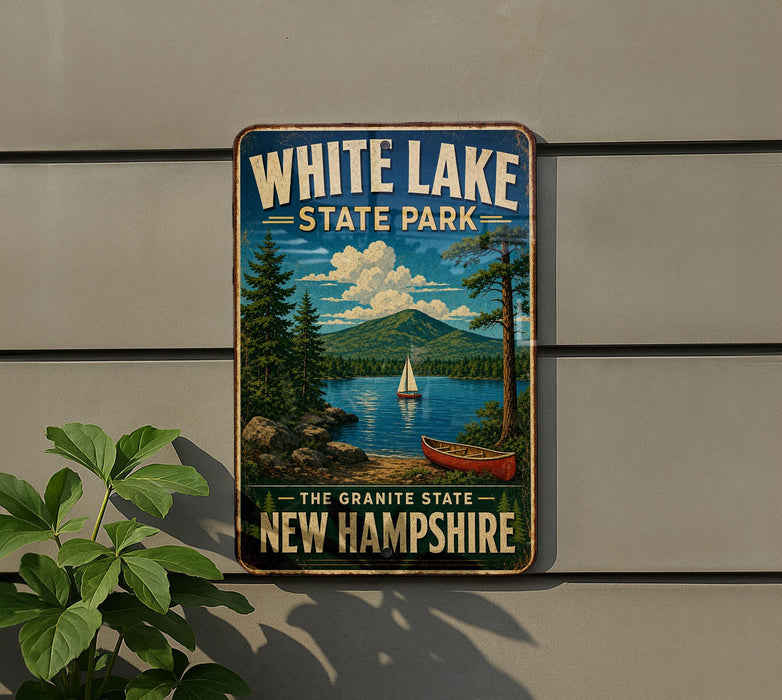 A vintage-style metal sign for White Lake State Park in New Hampshire, featuring a scenic landscape with a lake, mountains, pine trees, and a sailboat.