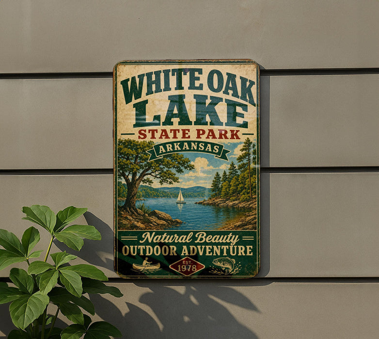 A vintage-style sign for White Oak Lake State Park in Arkansas, featuring a scenic landscape with a lake, trees, and a sailboat.