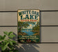 A vintage-style sign for White Oak Lake State Park in Arkansas, featuring a scenic landscape with a lake, trees, and a sailboat.