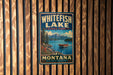 A vintage-style metal sign for Whitefish Lake State Park in Montana, featuring a scenic image of the lake and mountains.