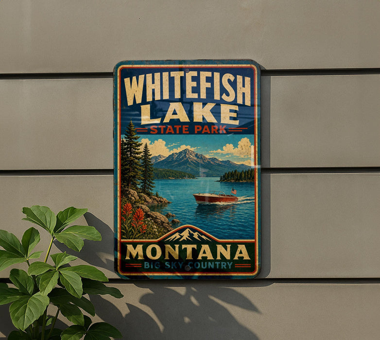 A vintage-style metal sign for Whitefish Lake State Park in Montana, featuring a scenic landscape with mountains, a lake, and a boat.