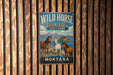 A vintage metal sign for Wild Horse Island State Park in Montana, featuring illustrations of horses and mountains.