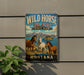 A vintage-style sign for Wild Horse Island State Park in Montana, featuring illustrations of three horses in a scenic landscape.