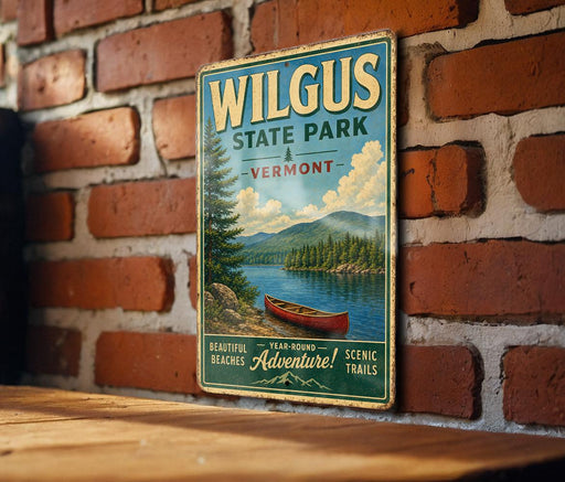 A vintage-style metal sign for Wilkus State Park in Vermont, featuring a scenic image of a lake with a canoe, mounted on a brick wall.