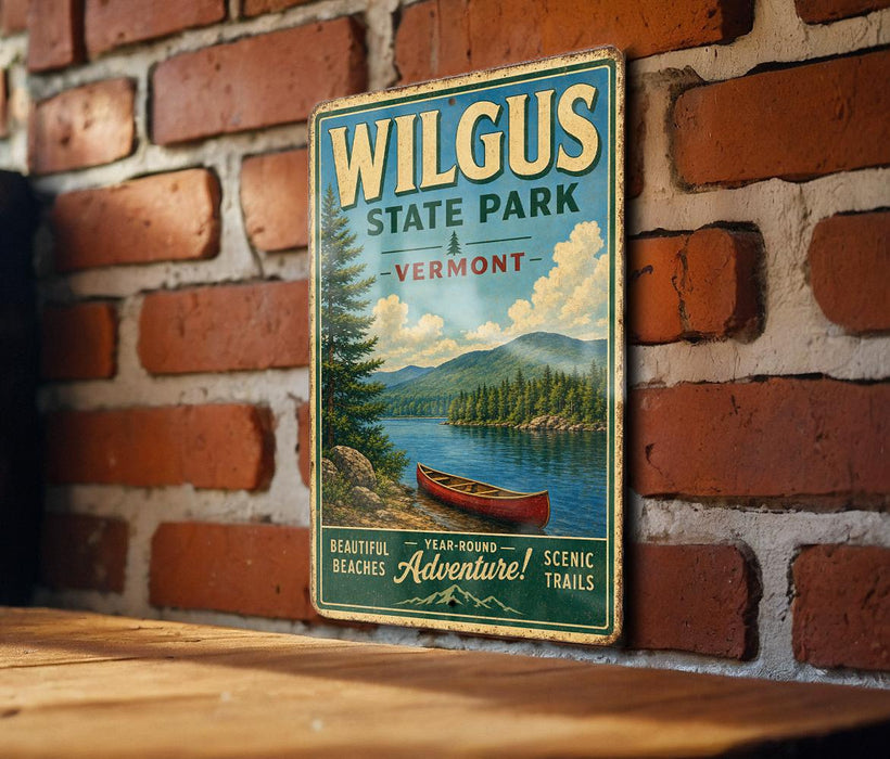 A vintage-style metal sign for Wilkus State Park in Vermont, featuring a scenic image of a lake with a canoe, mounted on a brick wall.