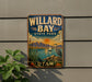 A vintage-style metal sign for Willard Bay State Park in Utah, featuring a scenic landscape with mountains, a lake, and a crane.