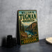 A vintage-style metal sign for William M. Tugman State Park in Oregon, featuring a scenic mountain landscape.