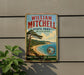 A vintage metal sign for William Mitchell State Park in Michigan, featuring a scenic landscape with a pine tree, beach, and ocean.
