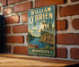 A vintage-style metal sign for William O'Brien State Park in Minnesota, featuring a scenic illustration of a lake, mountains, and a canoe.