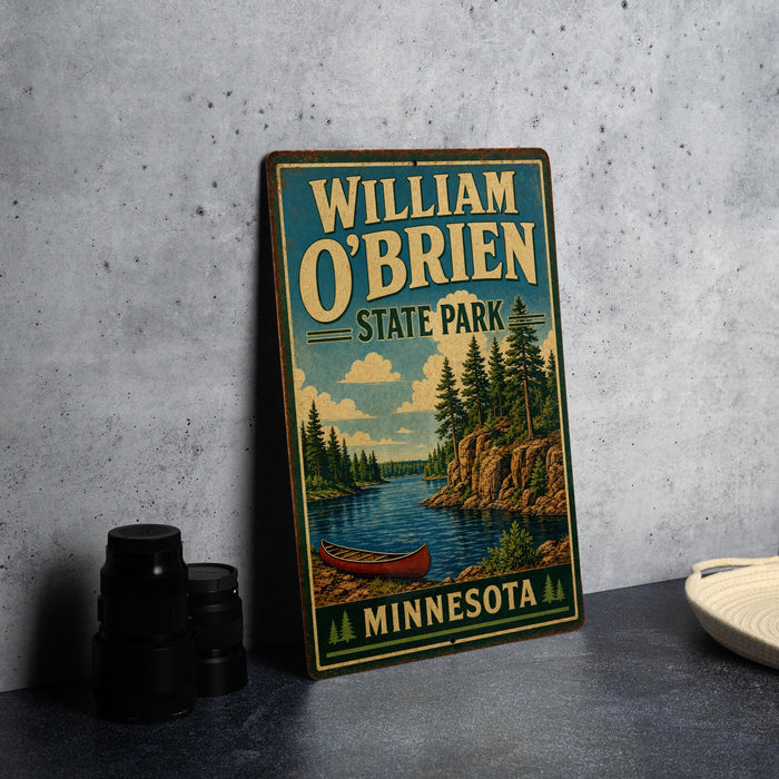 A vintage-style metal sign for William O'Brien State Park in Minnesota, featuring a scenic illustration of a lake, pine trees, and a canoe.