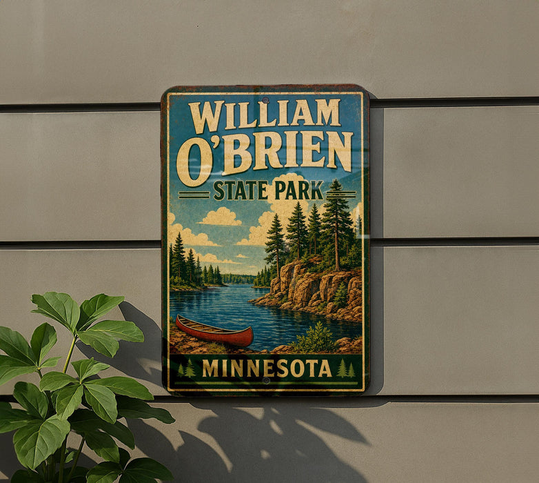 A vintage-style metal sign for William O'Brien State Park in Minnesota, featuring a scenic landscape with a lake, pine trees, and a canoe.