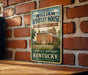 A vintage-style metal sign for the William Whitley House in Danville, Kentucky, is displayed on a brick wall.