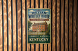 A vintage-style metal sign for the William Whitley House State Historic Site in Danville, Kentucky, with a picture of a historic house and a white picket fence.