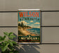 A vintage-style metal sign for Wilson State Park in Michigan, featuring a scenic landscape with pine trees, a beach, and a lake.
