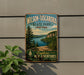 A vintage-style metal sign for Wilson-Tuscador State Park in New York, featuring a scenic landscape with a lake and mountains.