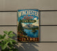A vintage-style metal sign for Winchester Lake State Park in Idaho, featuring a scenic landscape with mountains, pine trees, and a lake.