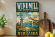 A vintage-style metal sign for the Windmill State Recreation Area in Nebraska, featuring a windmill, sailboat, and scenic landscape.