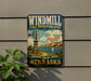 A vintage-style metal sign with a windmill and a scenic landscape, advertising the Windmill State Recreation Area in Nebraska.