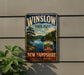 A vintage-style metal sign for Winslow State Park in New Hampshire, featuring a scenic landscape with pine trees, a lake, and mountains.
