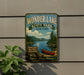 A vintage-style metal sign for Wonder Lake State Park in New York, featuring a scenic image of a lake, mountains, and a canoe.