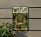 A metal sign on a wall that reads "Wormsloe Historic Site State Park Georgia".