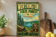 A vintage-style metal sign for WorthINGTON STATE FOREST, New Jersey, featuring a scenic landscape with pine trees, a river, and mountains.
