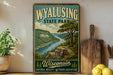 A vintage-style poster of Wyalusing State Park in Wisconsin, featuring a scenic landscape with a river and mountains, is displayed on a wall next to a wooden cutting board and some kitchen utensils.