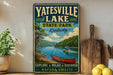 A vintage-style sign for Yatesville Lake State Park in Kentucky, featuring a scenic image of a canoe on the lake and a wooded area in the background.