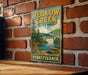 A vintage-style sign for Yellow Creek State Park in Pennsylvania, featuring a scenic illustration of the park and a picnic area.
