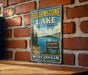 A vintage-style sign for Yellowstone Lake, Wisconsin, mounted on a brick wall.