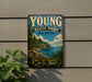 A vintage-style metal sign for Young State Park in Michigan, featuring a scenic landscape with pine trees, a lake, and mountains.